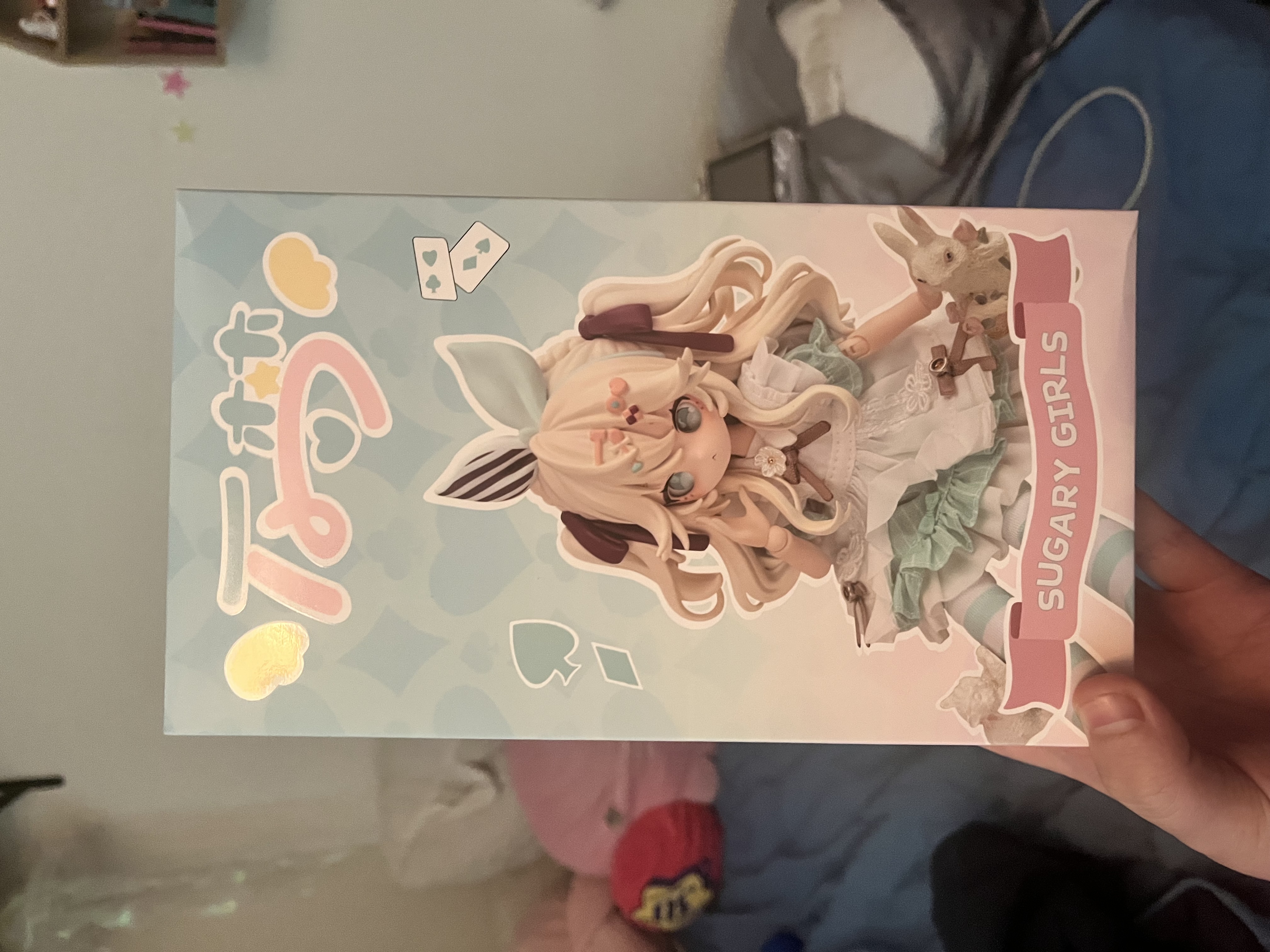 Box packaging for the Sugary Girls blind box line - Alice design with playing card motifs on a pink and blue pastel background, labeled "SUGARY GIRLS"