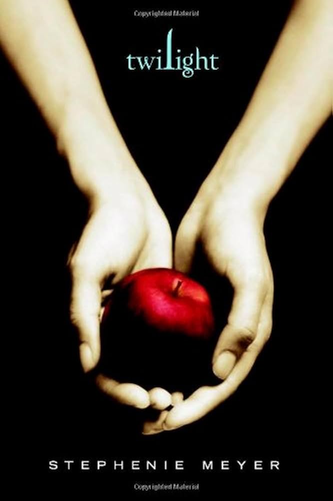 Two pale hands cradling a single red apple against a black background